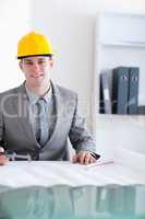 Close up of smiling architect working on a plan