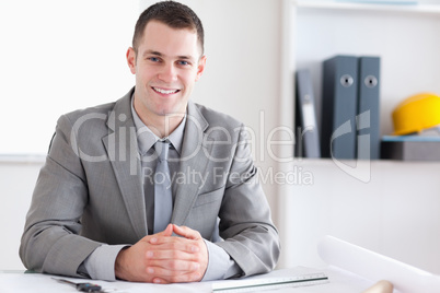 Smiling architect with folded hands