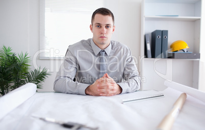 Architect sitting behind a table