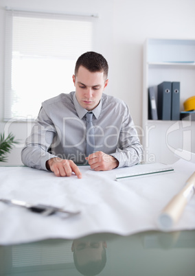 Close up of architect working on construction plan