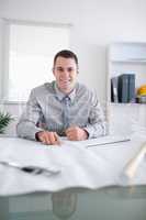 Close up of smiling architect working on a construction plan