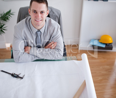 Architect sitting in front of a construction plan