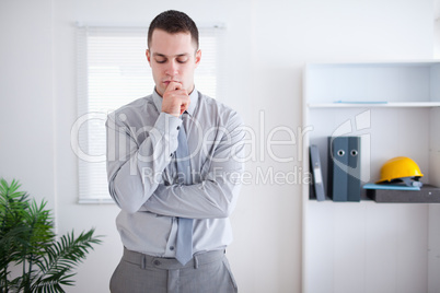 Businessman standing and thinking