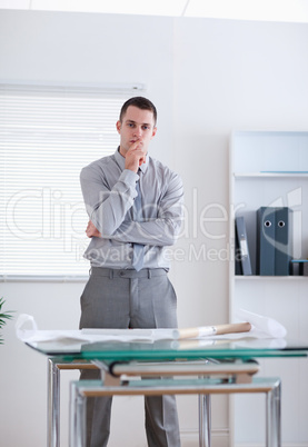 Businessman standing behind table