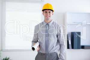 Architect wearing helm and carrying plans