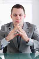 Close up of businessman sitting behind a table