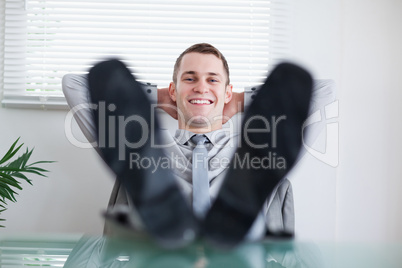 Young businessman sitting back