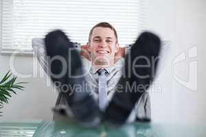 Young businessman sitting back