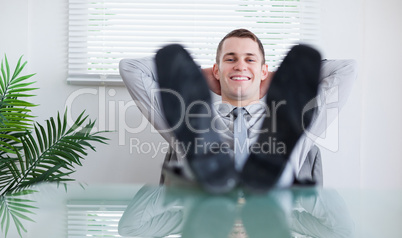 Smiling businessman sitting back