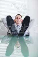 Close up of young businessman sitting back