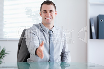 Smiling businessman greeting his negotiation partner