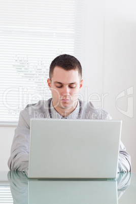 Close up of businessman working on his laptop