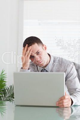 Close up of businessman having a problem with his laptop