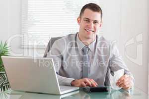 Smiling businessman checking an invoice