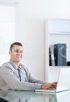 Happy businessman using his laptop