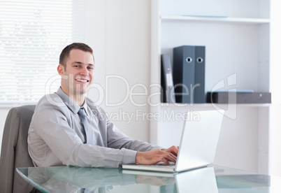 Satisfied businessman working on his laptop