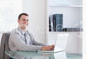 Satisfied businessman working on his laptop