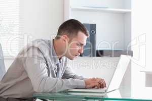 Businessman taking close look at his laptop