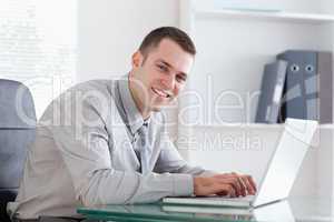 Businessman typing on his laptop