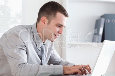 Close up of businessman writing an email with his laptop
