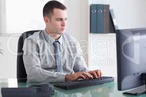 Businessman typing on his computer