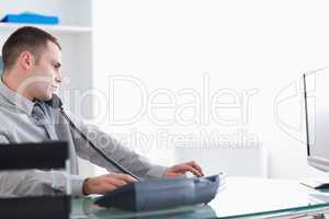Businessman leaning back while on the phone
