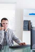 Smiling businessman listening to caller