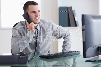 Businessman looking at the screen while on the phone