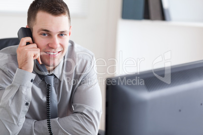 Businessman getting good news on the phone