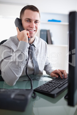 Smiling businessman having a dialogue on the phone