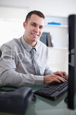 Happy businessman working on his computer