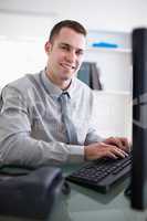 Happy businessman working on his computer