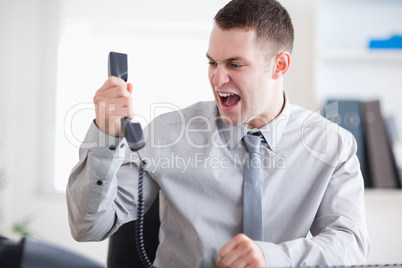 Businessman yelling at the phone