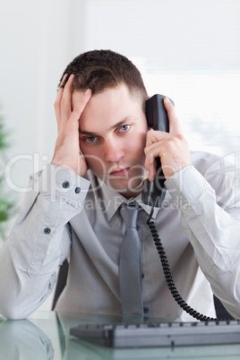 Depressed businessman on the phone