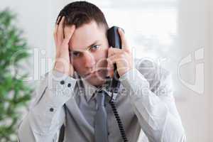 Businessman getting bad news on the phone