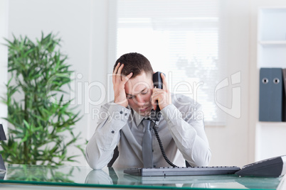 Businessman getting sad news on the phone