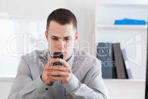 Businessman typing a text message