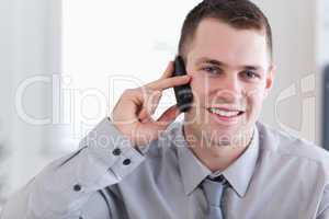 Smiling businessman getting good news on the phone