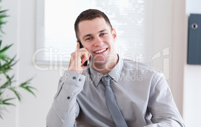 Businessman getting pleasant news on the mobile phone