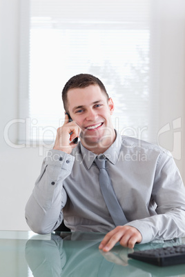 Happy businessman listening to caller