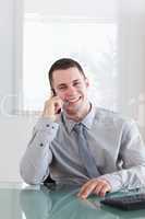 Happy businessman listening to caller