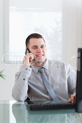 Smiling businessman getting good news on the cellphone