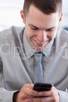 Close up of businessman getting a pleasant text message