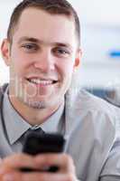 Close up of businessman with mobile phone in his hans