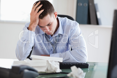 Close up of businessman frustrated with paperwork