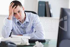 Close up of frustrated businessman doing his accounting