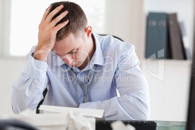Businessman stressed while doing his accounting