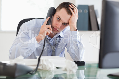Close up of frustrated businessman on the phone