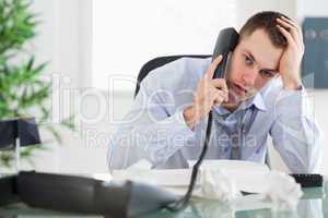 Troubled businessman on the phone