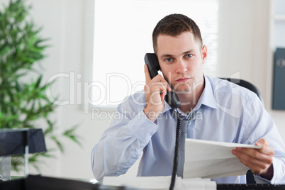 Businessman on the phone with the author of a letter